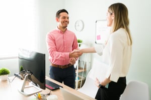 attractive-man-his-30s-caucasian-business-woman-meeting-first-time-smiling-male-female-coworkers-shaking-hands-office